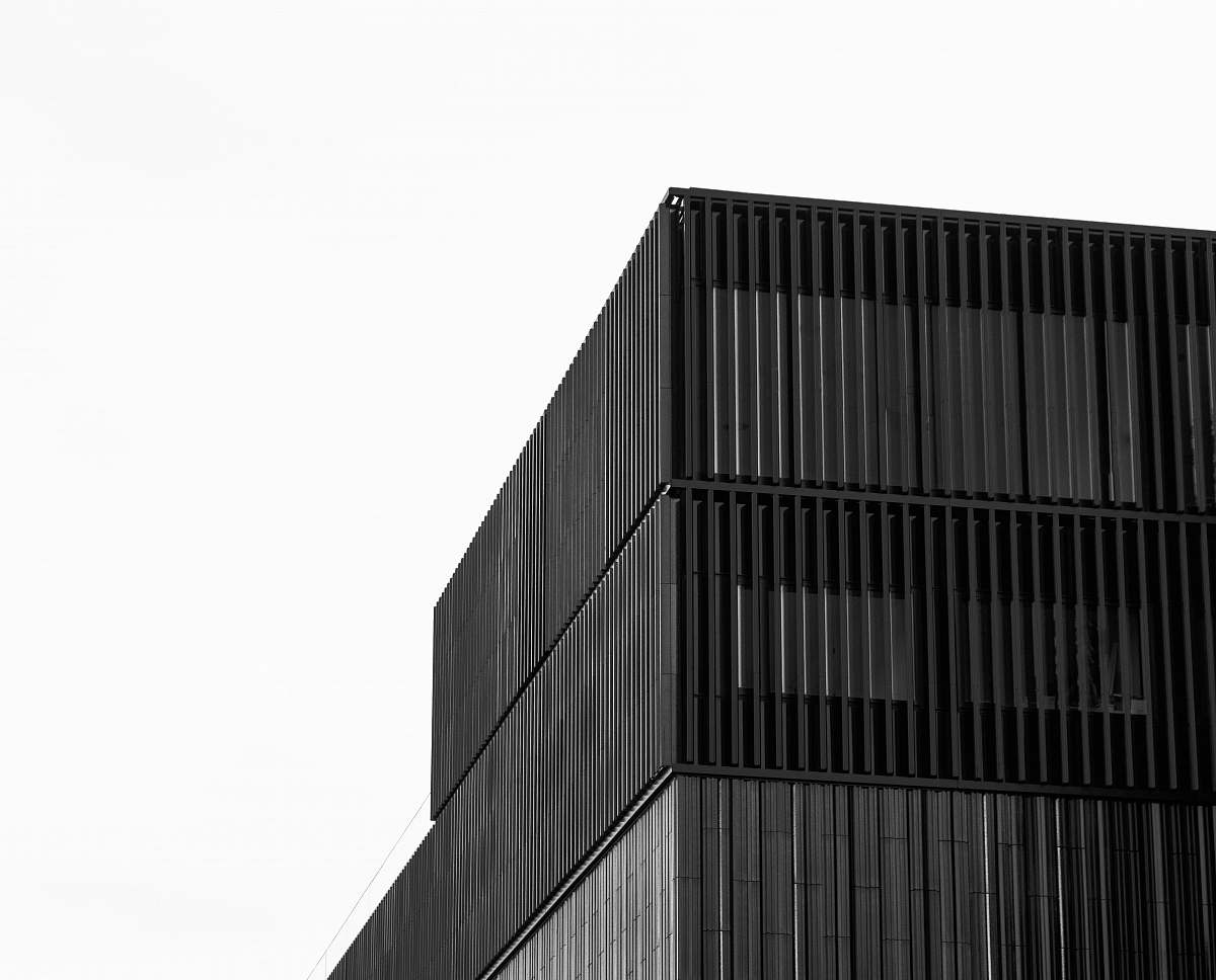 office building low-angle grayscale photography of a high-rise building gate